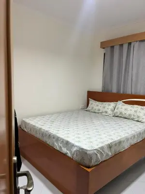a bedroom with a bed with a wooden headboard at Aconchego da Bety in Praia
