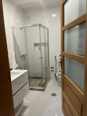 a bathroom with a glass shower and a toilet at Aconchego da Bety in Praia