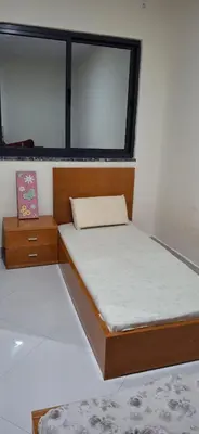 a small bedroom with two beds and a window at Aconchego da Bety in Praia