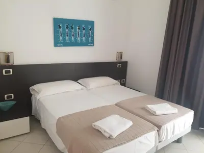 a bedroom with a bed with two towels on it at Aparthotel Por do Sol in Sal Rei