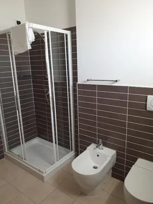 a bathroom with a shower and a toilet and a sink at Aparthotel Por do Sol in Sal Rei