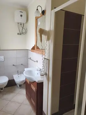 a bathroom with a sink and a toilet at Marialva Tropical T1 in Santa Maria