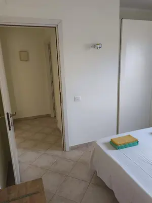 a room with a bed and a room with a door at Marialva Tropical T1 in Santa Maria