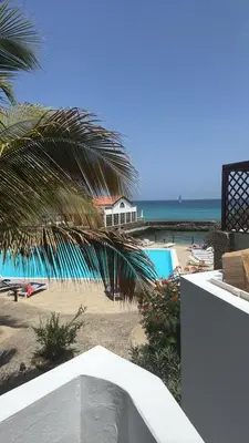a view of the beach from a balcony of a resort at Casa Anzso Ocean view Porto Antigo I in Santa Maria