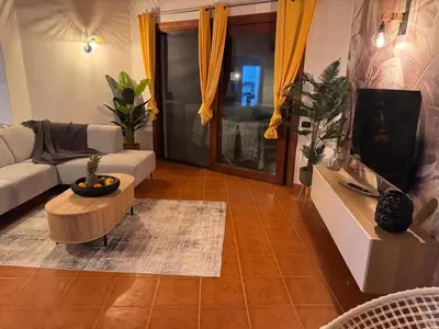 a living room with a couch and a table at Casa Anzso Ocean view Porto Antigo I in Santa Maria