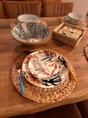 a wooden table with plates and bowls on it at Casa Anzso Ocean view Porto Antigo I in Santa Maria