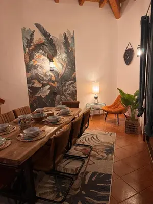a dining room with a table with chairs and a mural at Casa Anzso Ocean view Porto Antigo I in Santa Maria