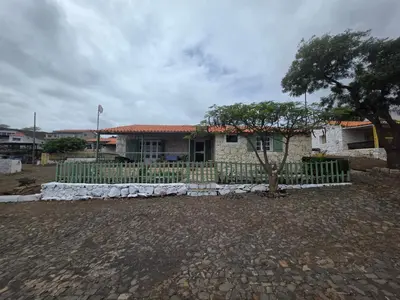 a house with a fence in front of it at Bougainvillea Villa in Cidade Velha
