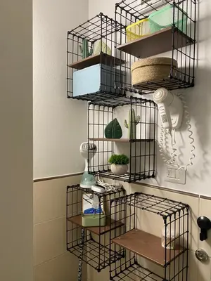 a black wire shelf with plants in a room at Tropical Anzso in Santa Maria