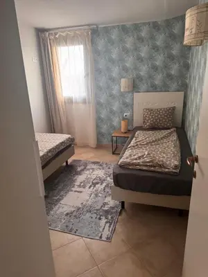 a bedroom with two beds and a window at Tropical Anzso in Santa Maria