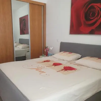 a bed with red roses on it in a bedroom at 3-bedroom Apartment Praia Santiago in Praia
