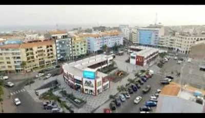 a city with a parking lot with cars and buildings at 3-bedroom Apartment Praia Santiago in Praia