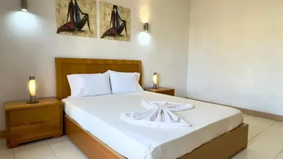 a bedroom with a bed with a plate on it at Exclusive 3-Bedroom Apartment Vila Verde Resort in Santa Maria