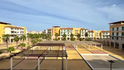 a group of benches in a city with buildings at Exclusive 3-Bedroom Apartment Vila Verde Resort in Santa Maria