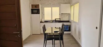 a kitchen with a table and chairs in a room at Ines Studio T0 - Inforsal in Espargos