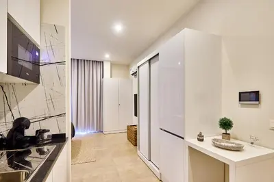 a kitchen with white cabinets and a counter top at Terra Boa beach apartment Sal Cabo Verde in Santa Maria