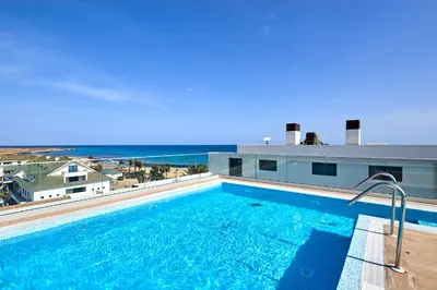 a swimming pool with a view of the ocean at Terra Boa beach apartment Sal Cabo Verde in Santa Maria