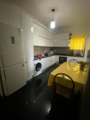 a kitchen with a table with a yellow table cloth at Cozy Apartment, 3 Bedrooms in Praia