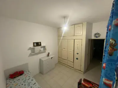 a bedroom with white cabinets and a bed in it at Cozy Apartment, 3 Bedrooms in Praia