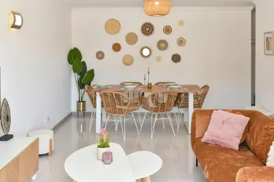 a living room with a table and chairs at Gorgeous 3-bdr apt - 1-min laginha beach - LCGR in Mindelo