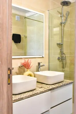 a bathroom with two sinks and a shower at Gorgeous 3-bdr apt - 1-min laginha beach - LCGR in Mindelo