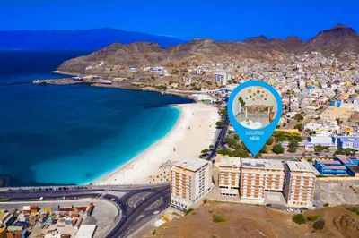 an aerial view of a beach with a blue sign at Gorgeous 3-bdr apt - 1-min laginha beach - LCGR in Mindelo