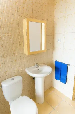 a bathroom with a white toilet and a sink at Casa di Mar in Santa Maria