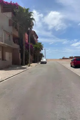 a car driving down a street next to a building at Casa di Mar in Santa Maria