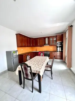 a kitchen with a table and chairs and a table and a kitchen at Casa BB&Djassi - Apartment T3 in Ponta do Sol