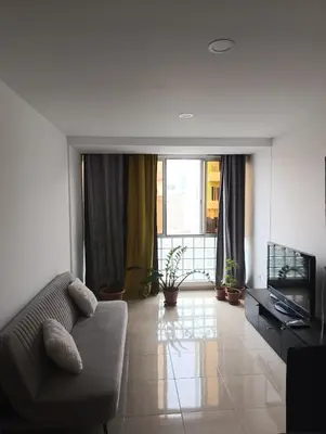 a living room with a couch and a television at Sossego & Conforto in Espargos