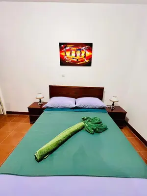a bedroom with a bed with a pickle on it at Casa BB&Djassi - Apartment T1 in Ponta do Sol
