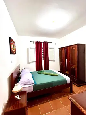 a bedroom with a bed with a red curtain at Casa BB&Djassi - Apartment T1 in Ponta do Sol