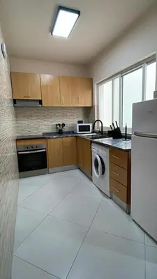 a kitchen with a refrigerator and a dishwasher at Apartamentos Esperança in Sal Rei
