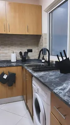 a kitchen with a sink and a washing machine at Apartamentos Esperança in Sal Rei