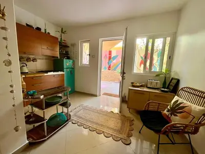 a kitchen with a refrigerator and a table and chairs at Joia Escondida in Santa Maria