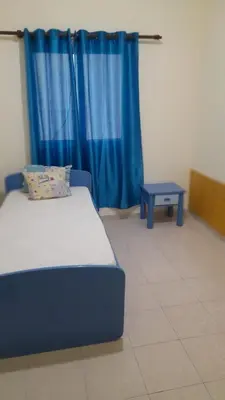 a bedroom with a blue bed and a blue table at Apart SilvaGomes in Praia
