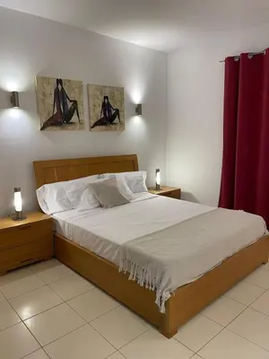 a bedroom with a large bed with two night stands at Cosy 2 Bed Apartment Vila Verde Santa Maria in Santa Maria