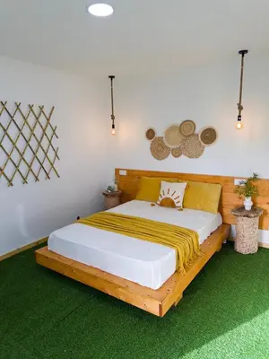 a bedroom with a wooden bed with a yellow blanket on it at Quinta Refúgio in Ribeirão Chiqueiro