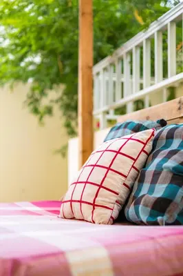 a bed with two pillows sitting on top of it at Simabo's Backpackers' Hostel in Mindelo
