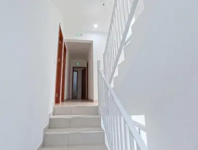 a hallway with white stairs in a house at Residencial Mãe Nona in Ribeira Grande