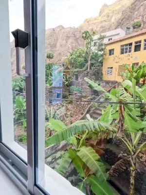 a window with a view of a mountain at Residencial Mãe Nona in Ribeira Grande