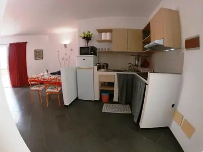 a kitchen and dining room with a table and a kitchen and a kitchen at Endless Summer B6 in Sal Rei