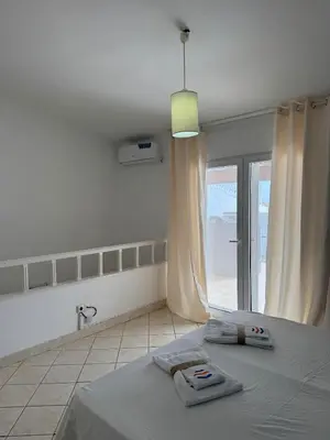 a bedroom with a bed and a large window at Murdeira V152 Duplex by RPG Group in Beirona
