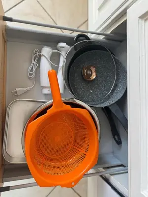 an orange pot and pans in a drawer at Murdeira V152 Duplex by RPG Group in Beirona