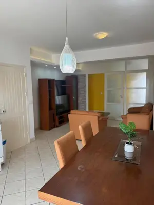 a dining room and living room with a table and chairs at Murdeira V152 Duplex by RPG Group in Beirona