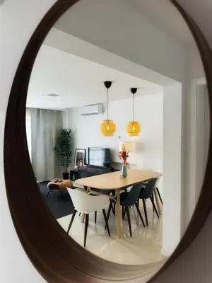 a dining room with a table and chairs in a mirror at Mindelo Bay Apartment in Mindelo
