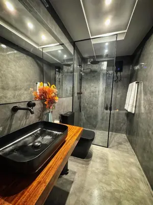 a bathroom with a black sink and a shower at Mindelo Bay Apartment in Mindelo
