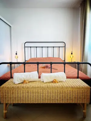 a bed with two pillows on top of it at Mindelo Bay Apartment in Mindelo