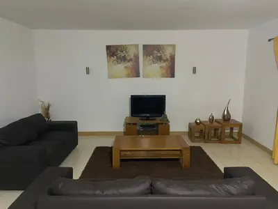 a living room with a couch and a coffee table at Raphis-Belux in Santa Maria