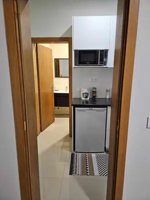 a small kitchen with a stove and a microwave at Sheila Apartment in Espargos